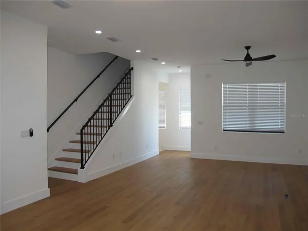 a view of an entryway with wooden floor and stairs