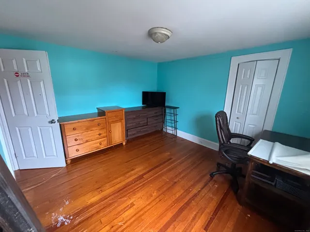 a view of a workspace with furniture and wooden floor