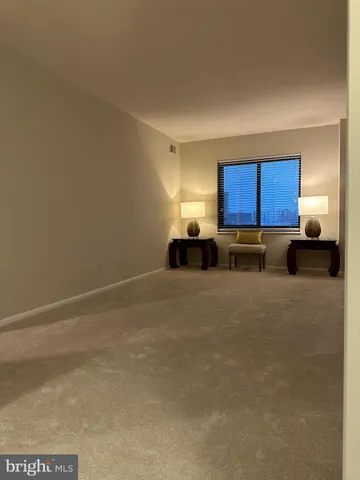 a view of kitchen with kitchen island a sink wooden floor and black cabinet