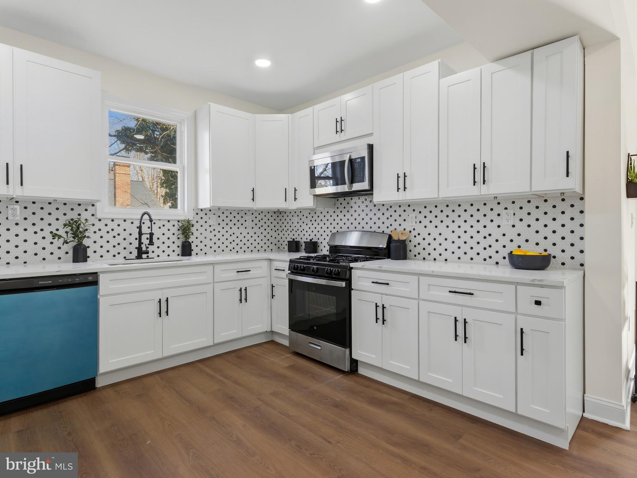 4600 White Avenue Baltimore, MD 21206 - Photo 12 of 40 a kitchen with stainless steel appliances white cabinets and sink