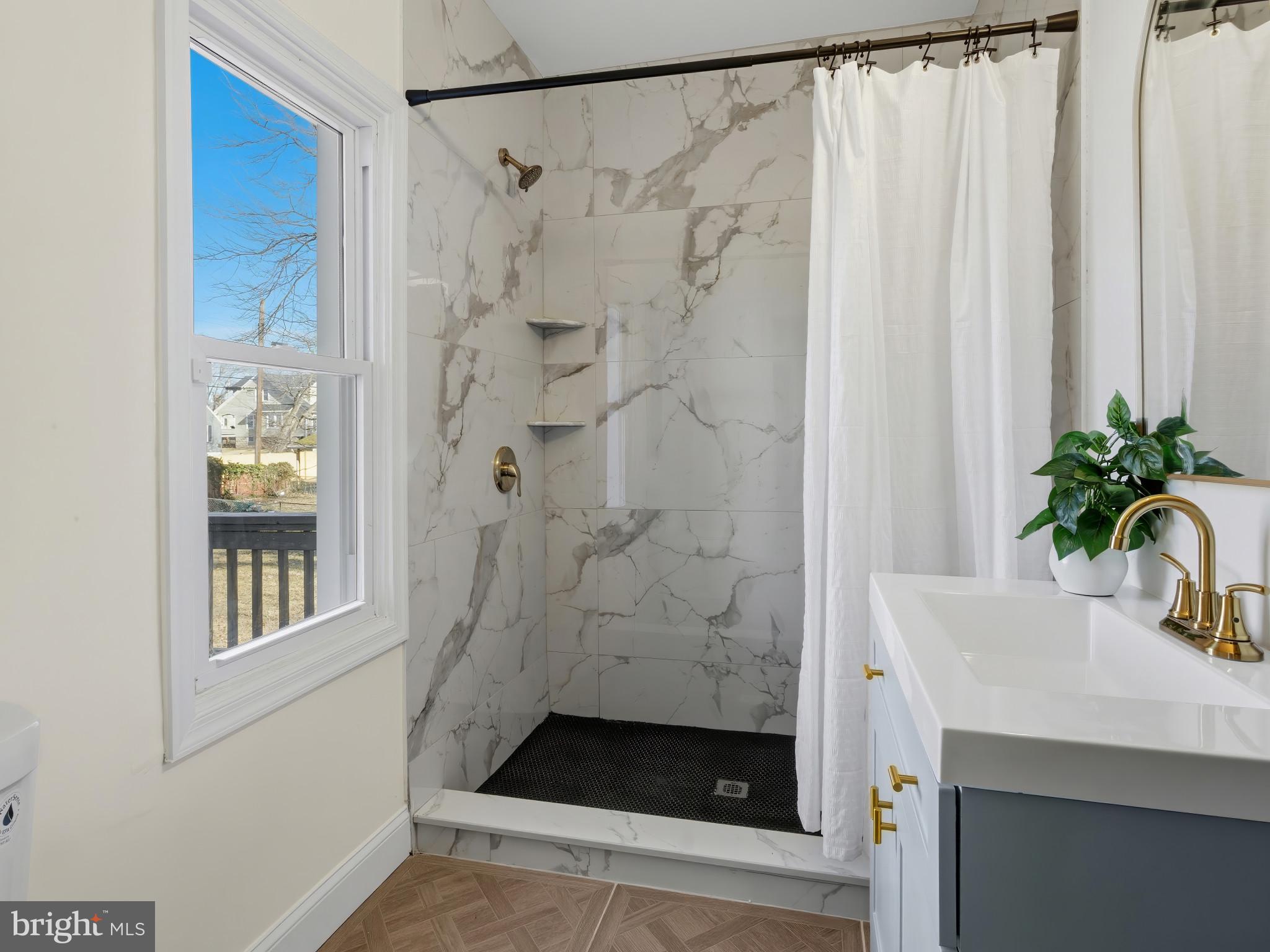 4600 White Avenue Baltimore, MD 21206 - Photo 14 of 40 a bathroom with a shower and a sink