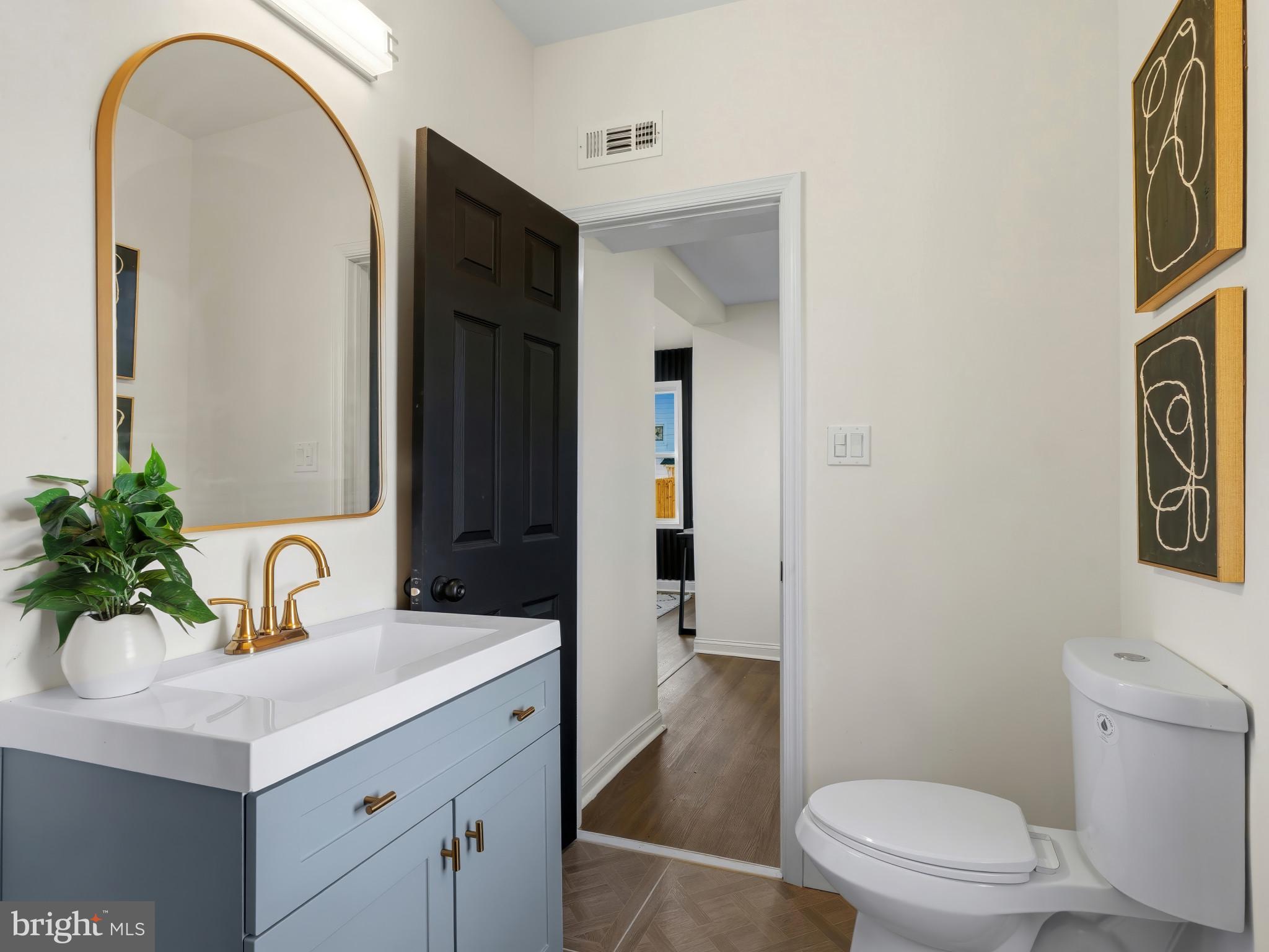 4600 White Avenue Baltimore, MD 21206 - Photo 15 of 40 a bathroom with a sink a toilet and mirror