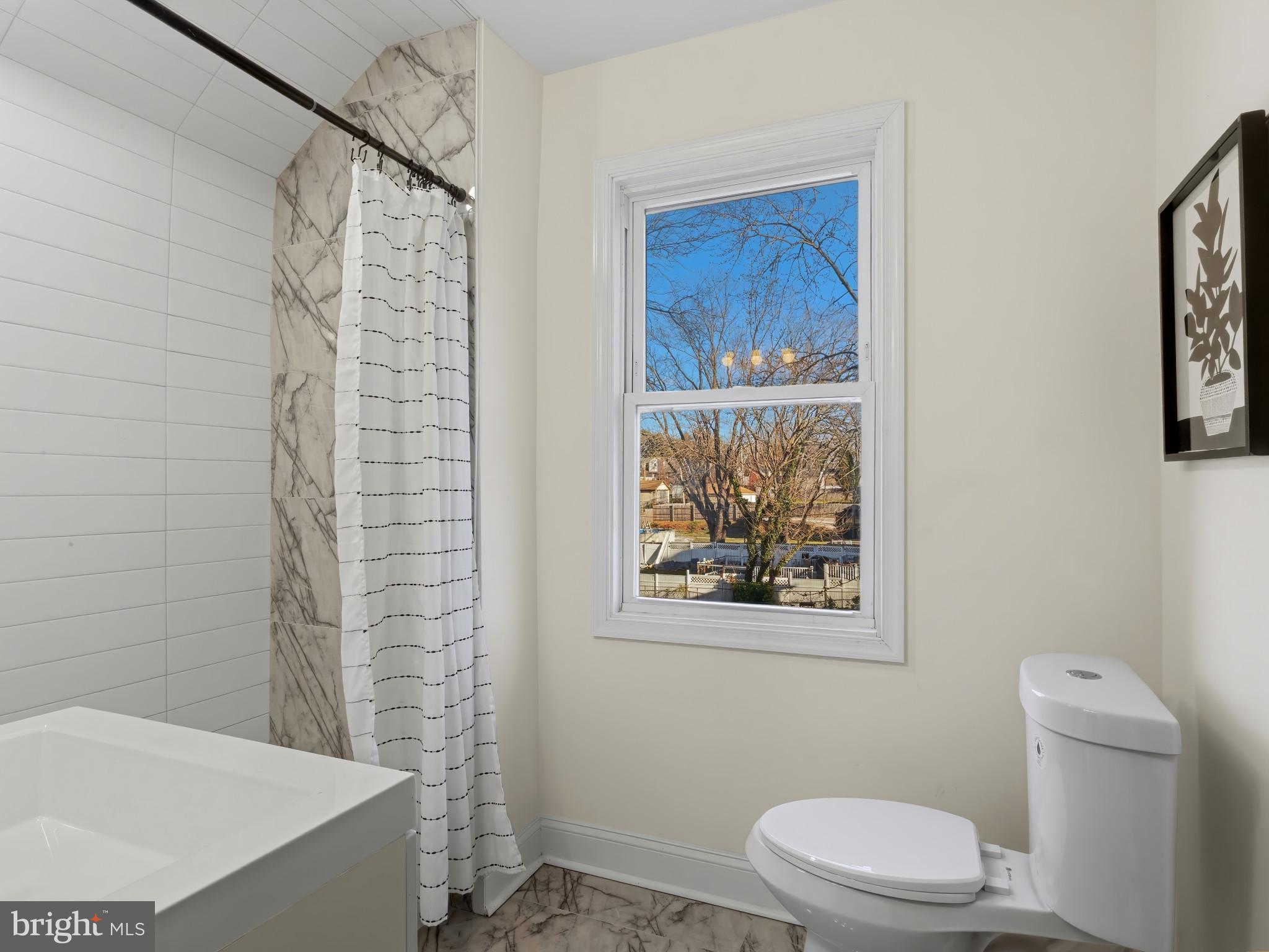 4600 White Avenue Baltimore, MD 21206 - Photo 19 of 40 a bathroom with a toilet and a shower