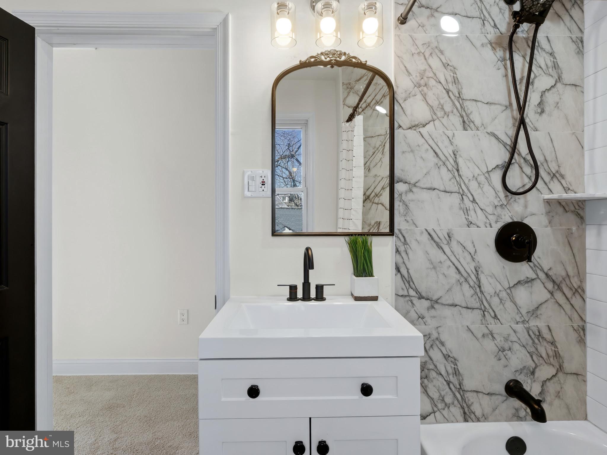4600 White Avenue Baltimore, MD 21206 - Photo 20 of 40 a bathroom with a sink and mirror