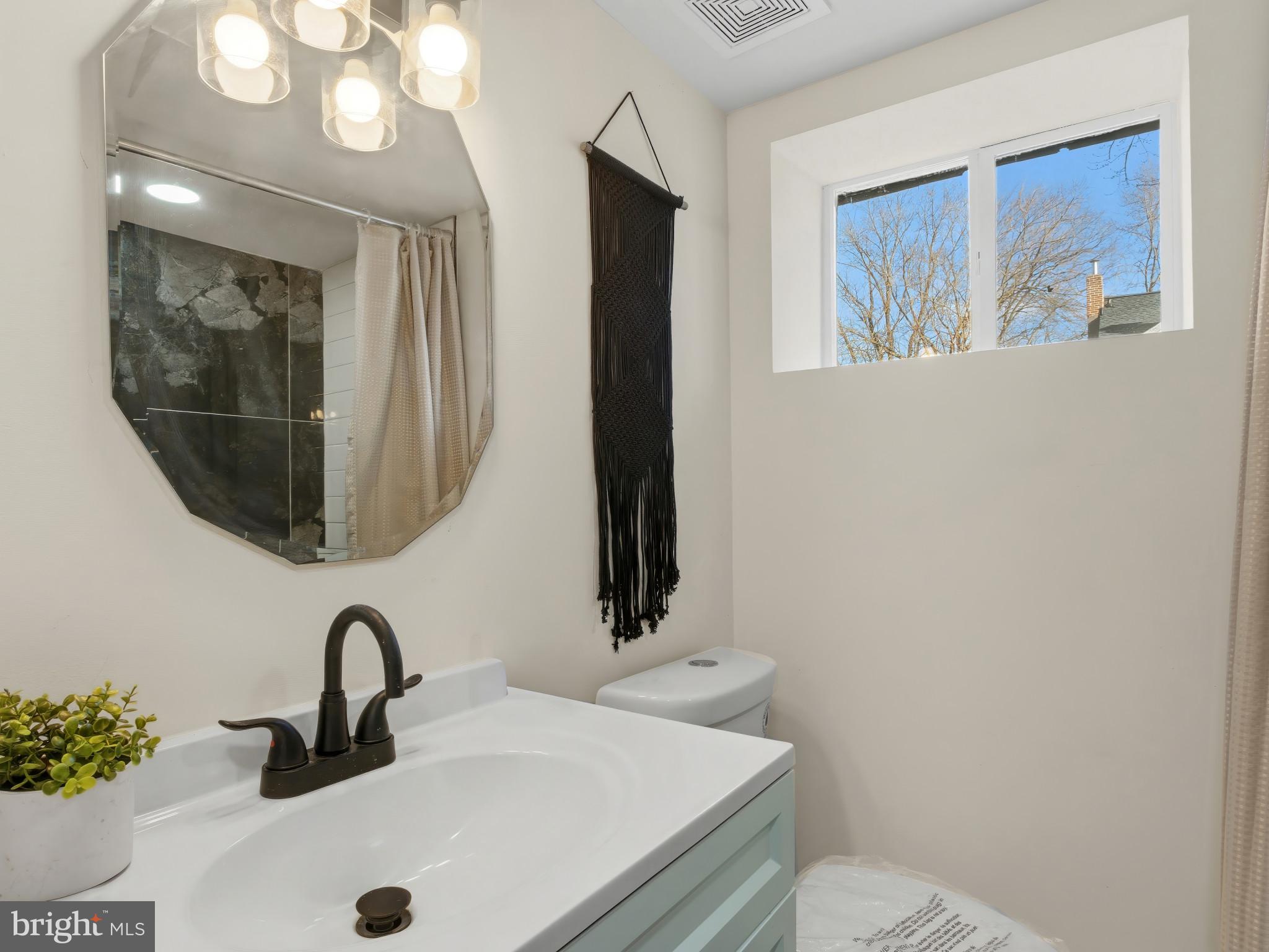 4600 White Avenue Baltimore, MD 21206 - Photo 34 of 40 a bathroom with a sink and a mirror