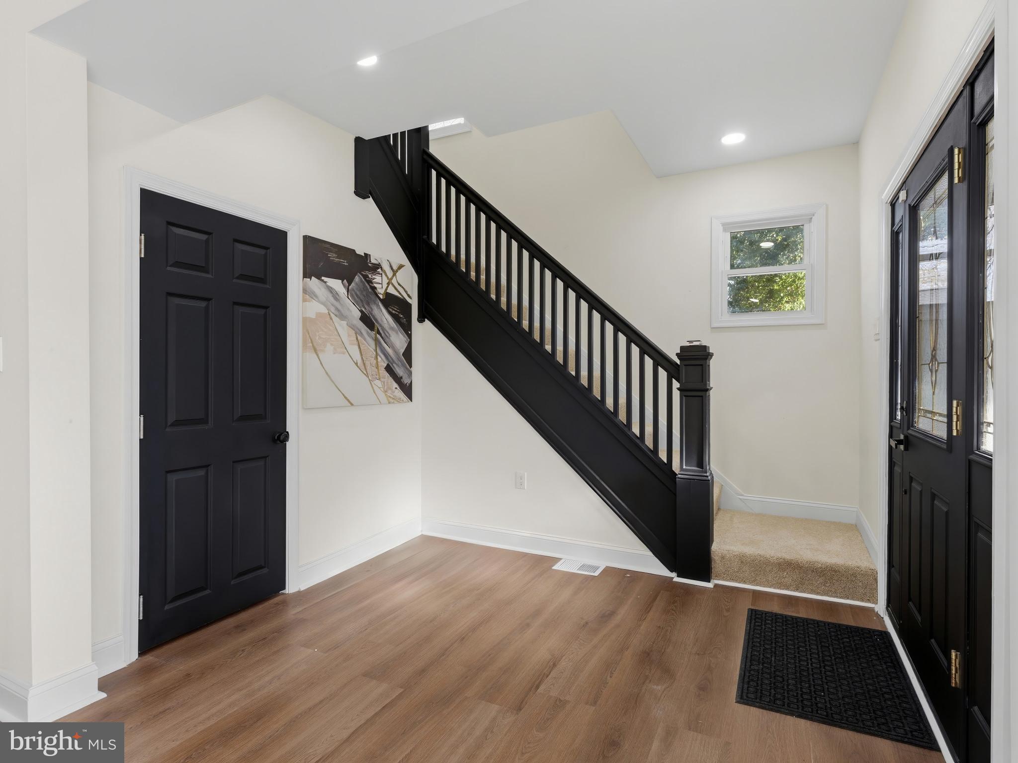 4600 White Avenue Baltimore, MD 21206 - Photo 7 of 40 a view of a hallway with wooden floor and stairs