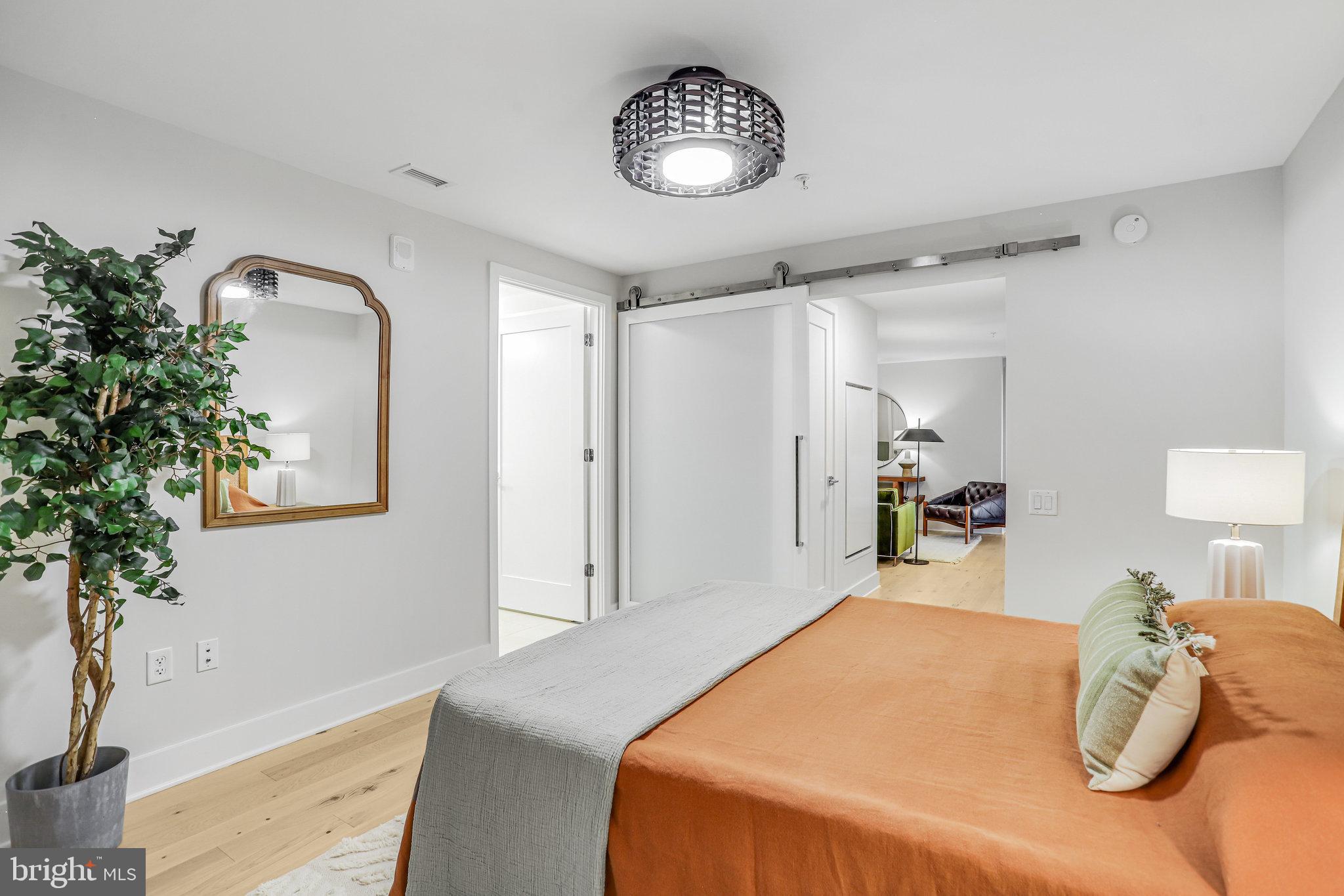 1211 Van Street Southeast, Unit 501 Washington, DC 20003 - Photo 11 of 37 a bedroom with a bed and a potted plant