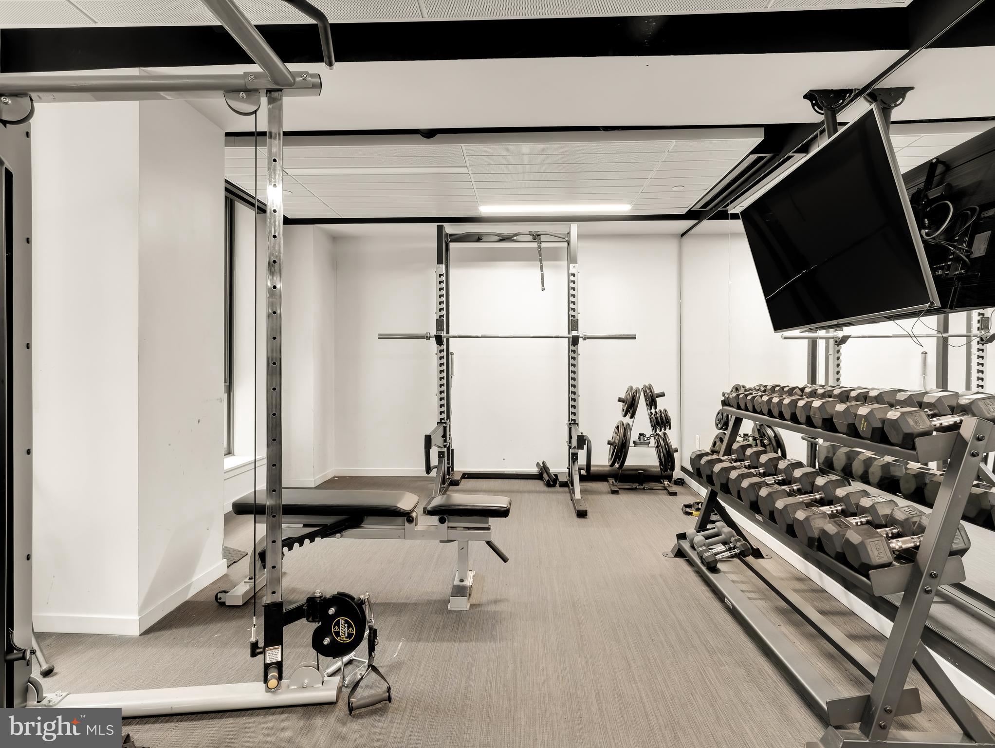 1211 Van Street Southeast, Unit 501 Washington, DC 20003 - Photo 14 of 37 a room with gym equipment and a large window