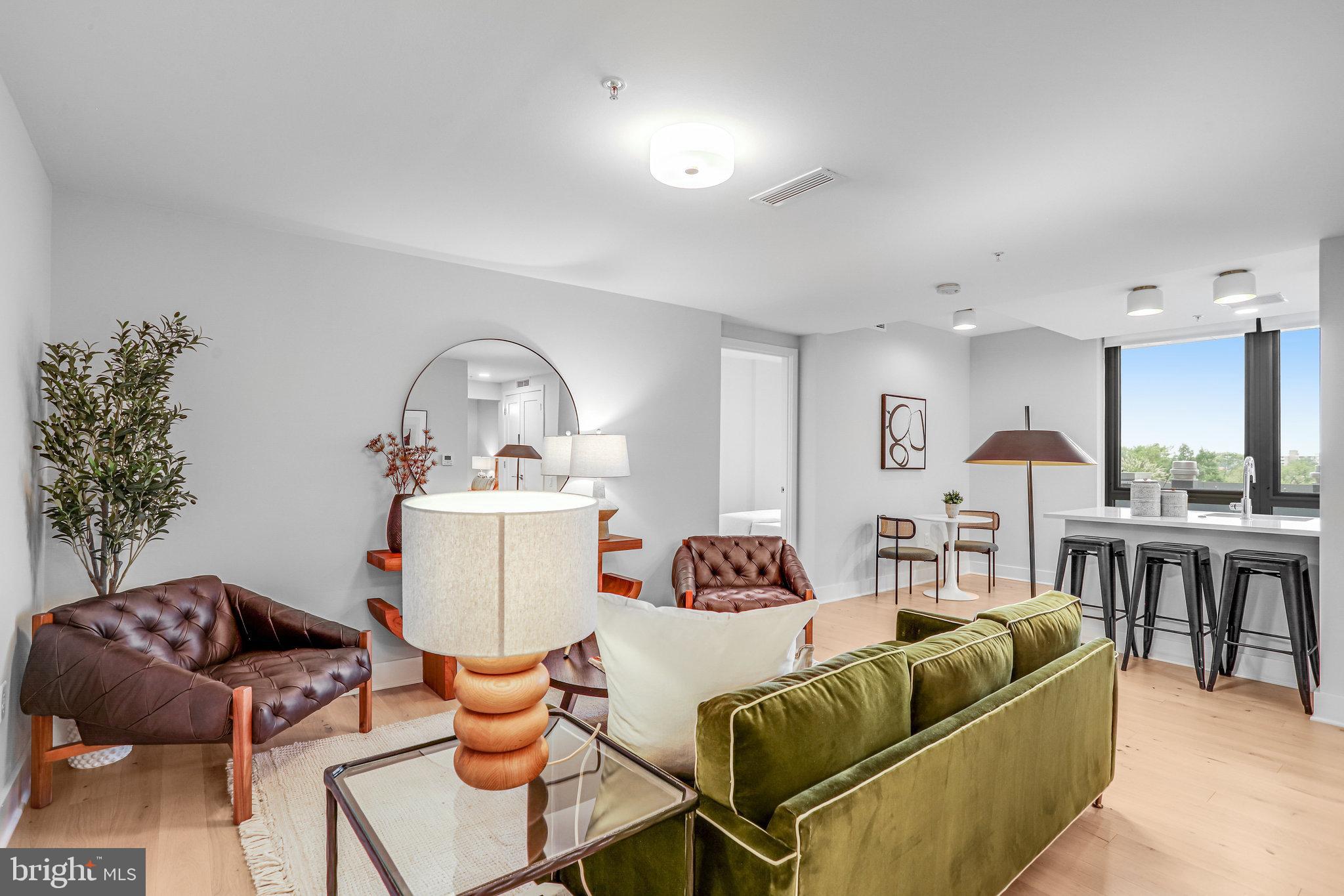 1211 Van Street Southeast, Unit 501 Washington, DC 20003 - Photo 2 of 37 a living room with furniture and a large window