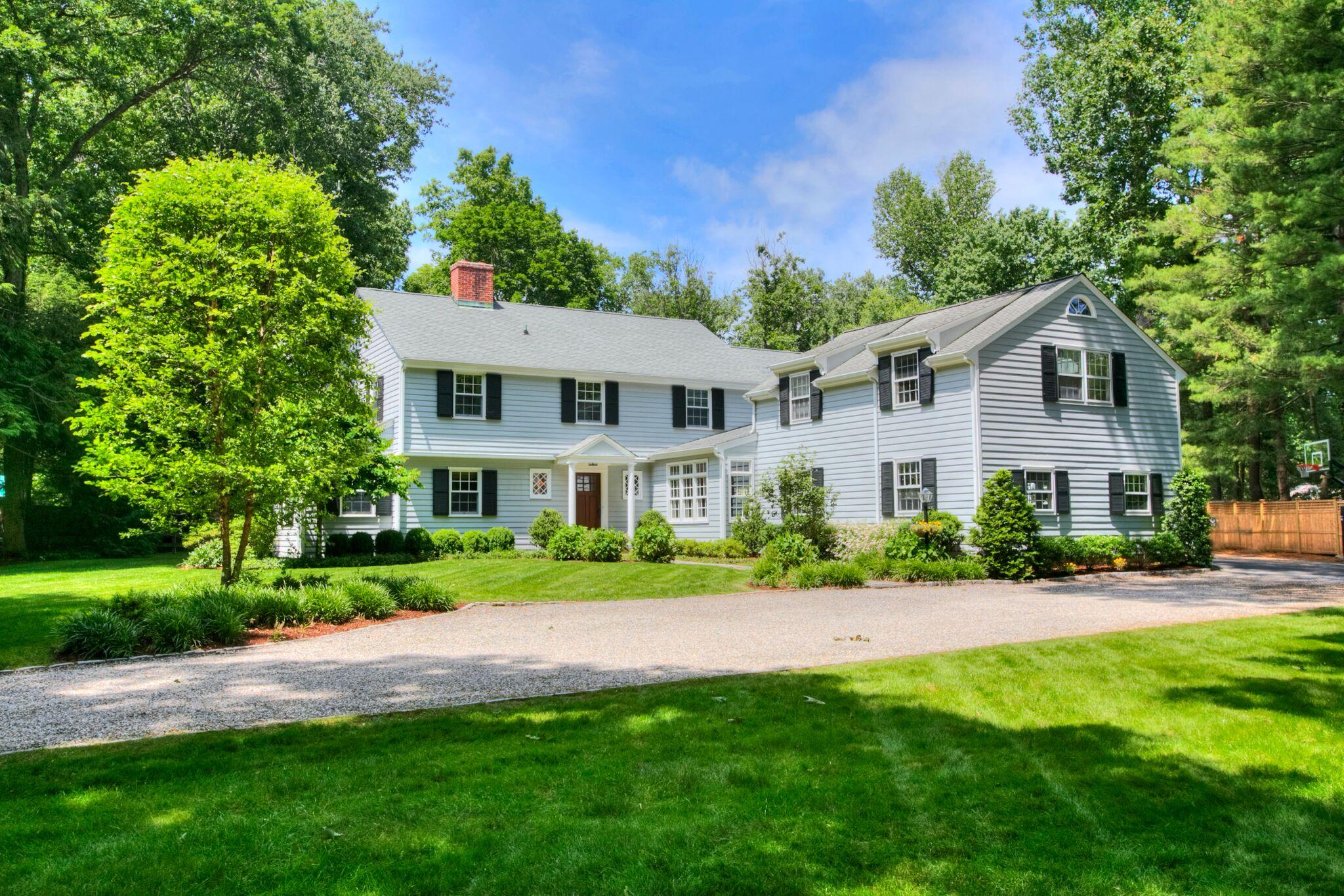 5 Haskell Lane Darien, CT 06820 - Photo 1 of 22 a front view of a house with a yard and trees