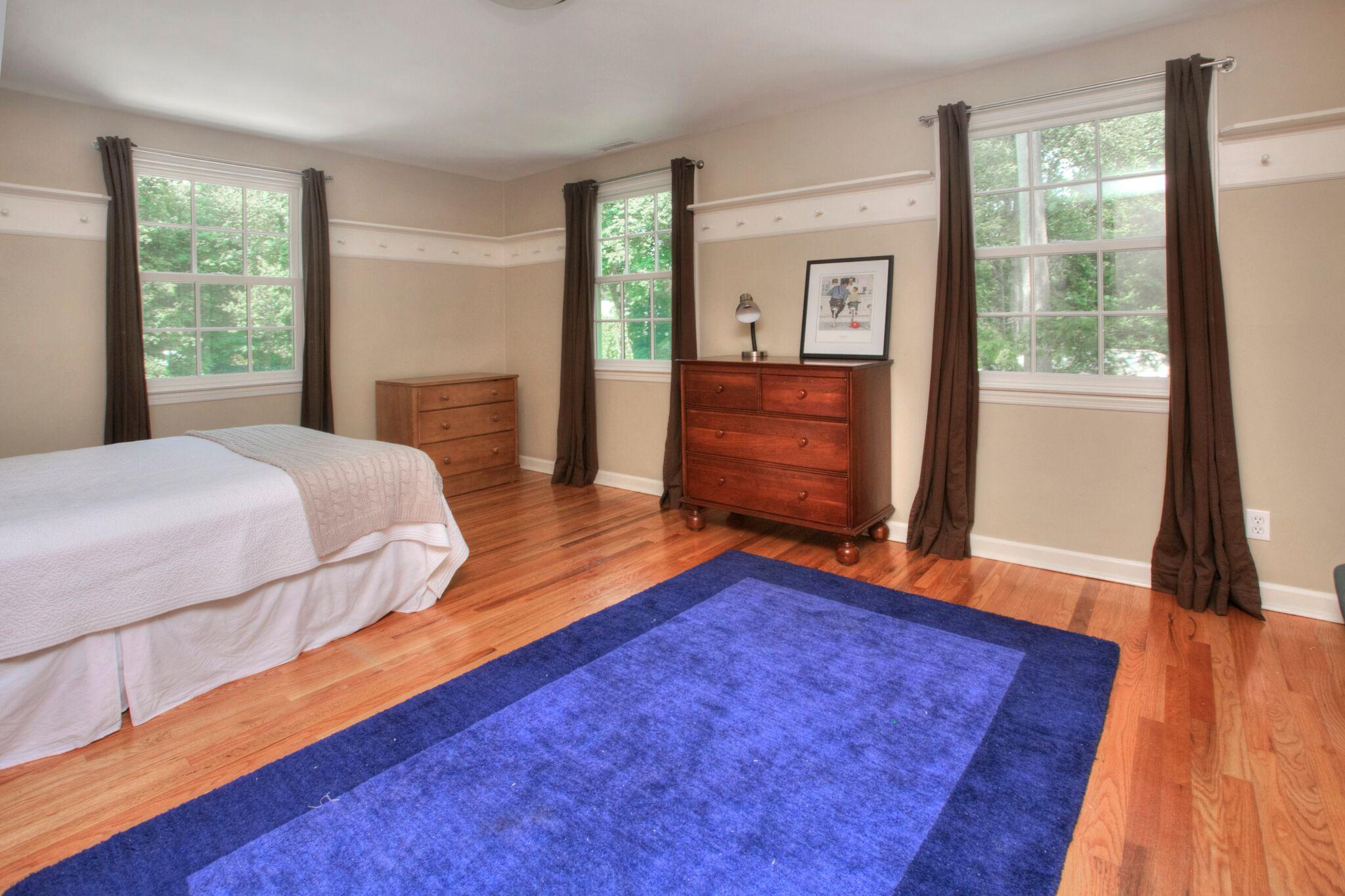 5 Haskell Lane Darien, CT 06820 - Photo 14 of 22 a bedroom with a bed and wooden floor