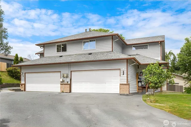 a front view of a house with a yard and garage