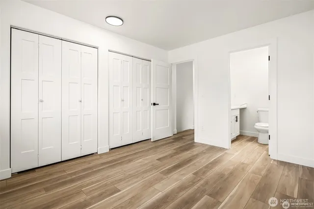 a view of a room with wooden floor