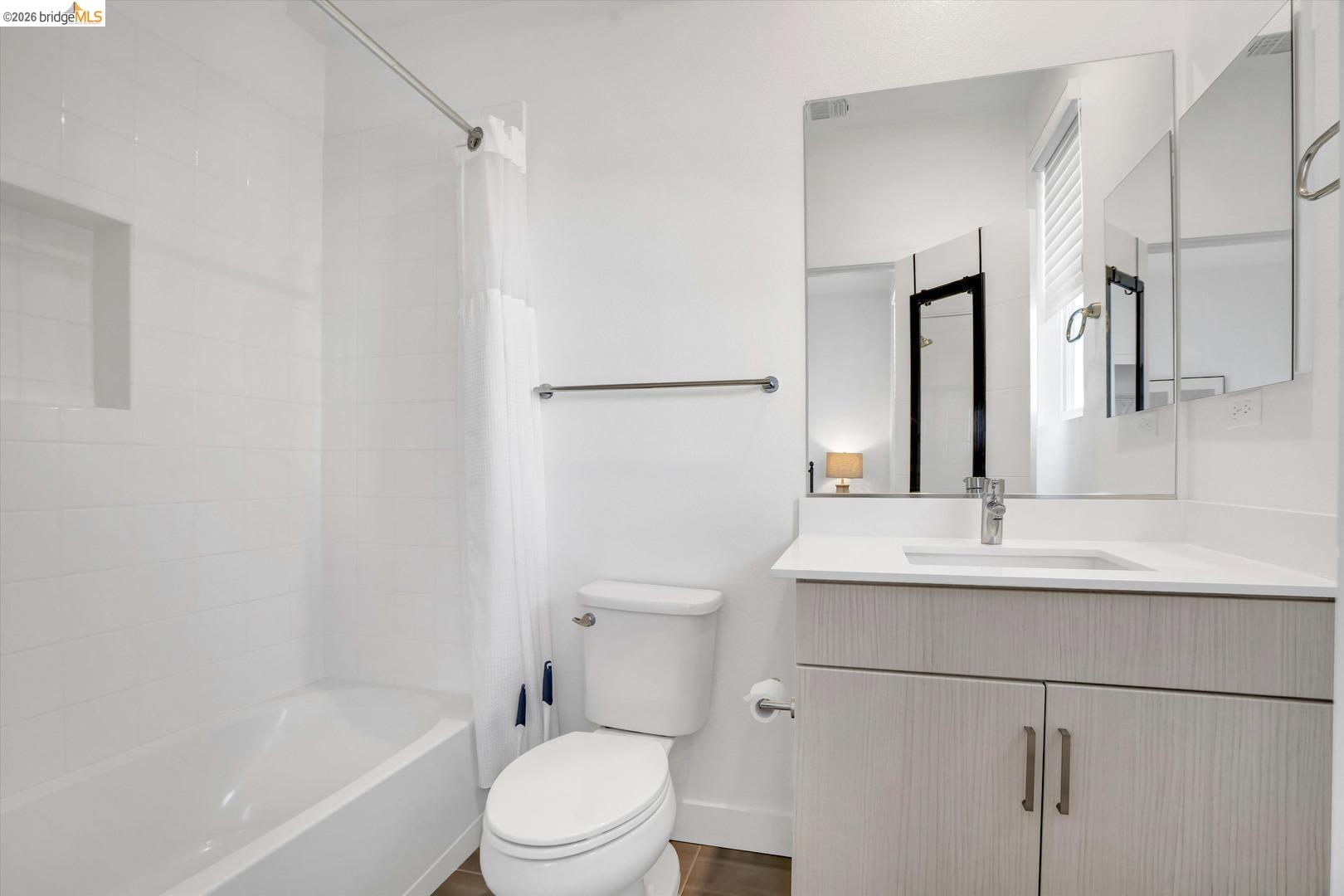2229 Myrtle Street Oakland, CA 94607 - Photo 28 of 37 full bathroom featuring vanity and shower / bath combo with shower curtain