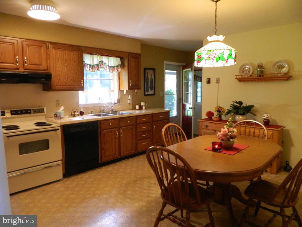 5 Hilltop Road Lititz, PA 17543 - Photo 5 of 12 a kitchen with a table chairs stove and microwave