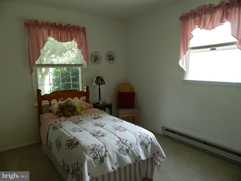 5 Hilltop Road Lititz, PA 17543 - Photo 8 of 12 a bed sitting in a bedroom next to a window
