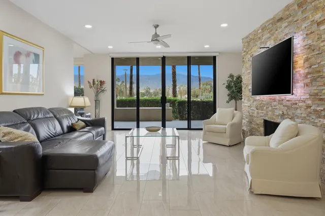 a living room with fireplace furniture and a flat screen tv
