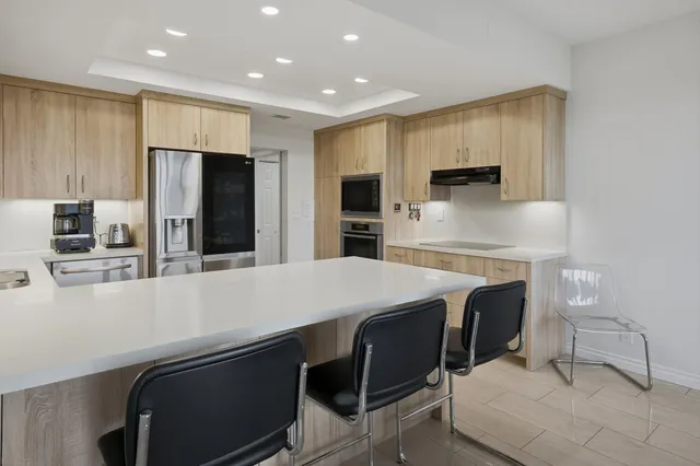 a kitchen with a sink and a refrigerator
