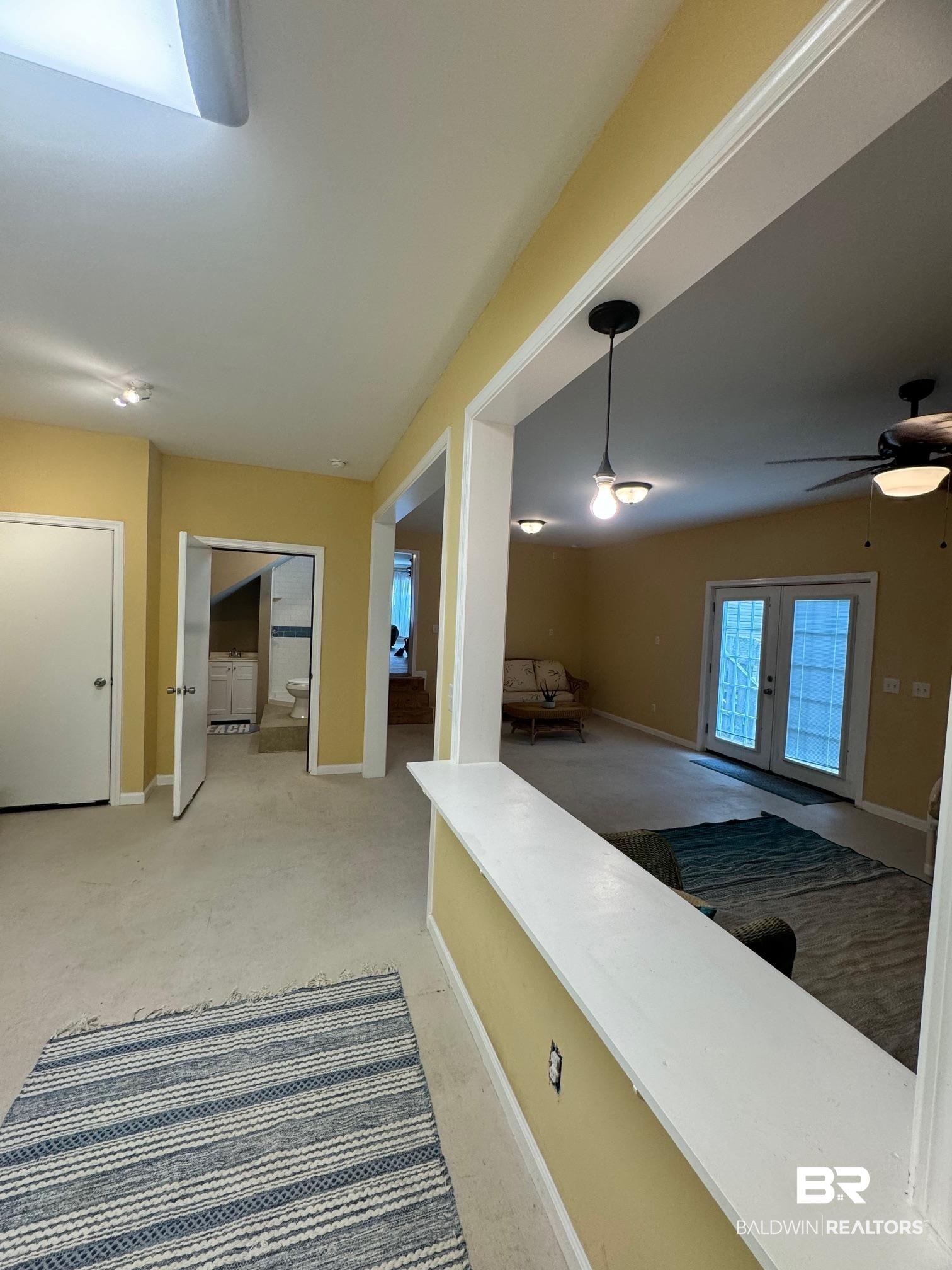 1985 Ridgewood Drive South Lillian, AL 36549 - Photo 16 of 40 Interior space with carpet flooring, hanging light fixtures, and ceiling fan