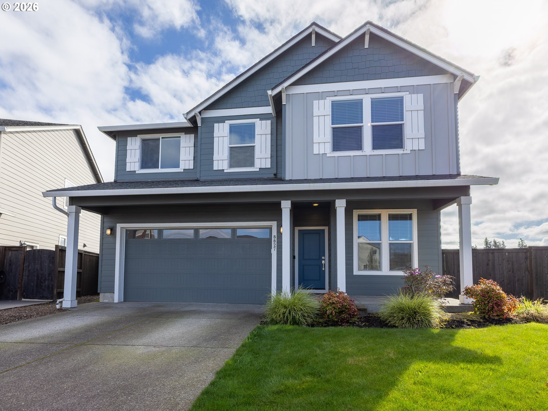 8827 North 1st Circle Ridgefield, WA 98642 - Photo 1 of 38 a front view of a house with a yard and garage