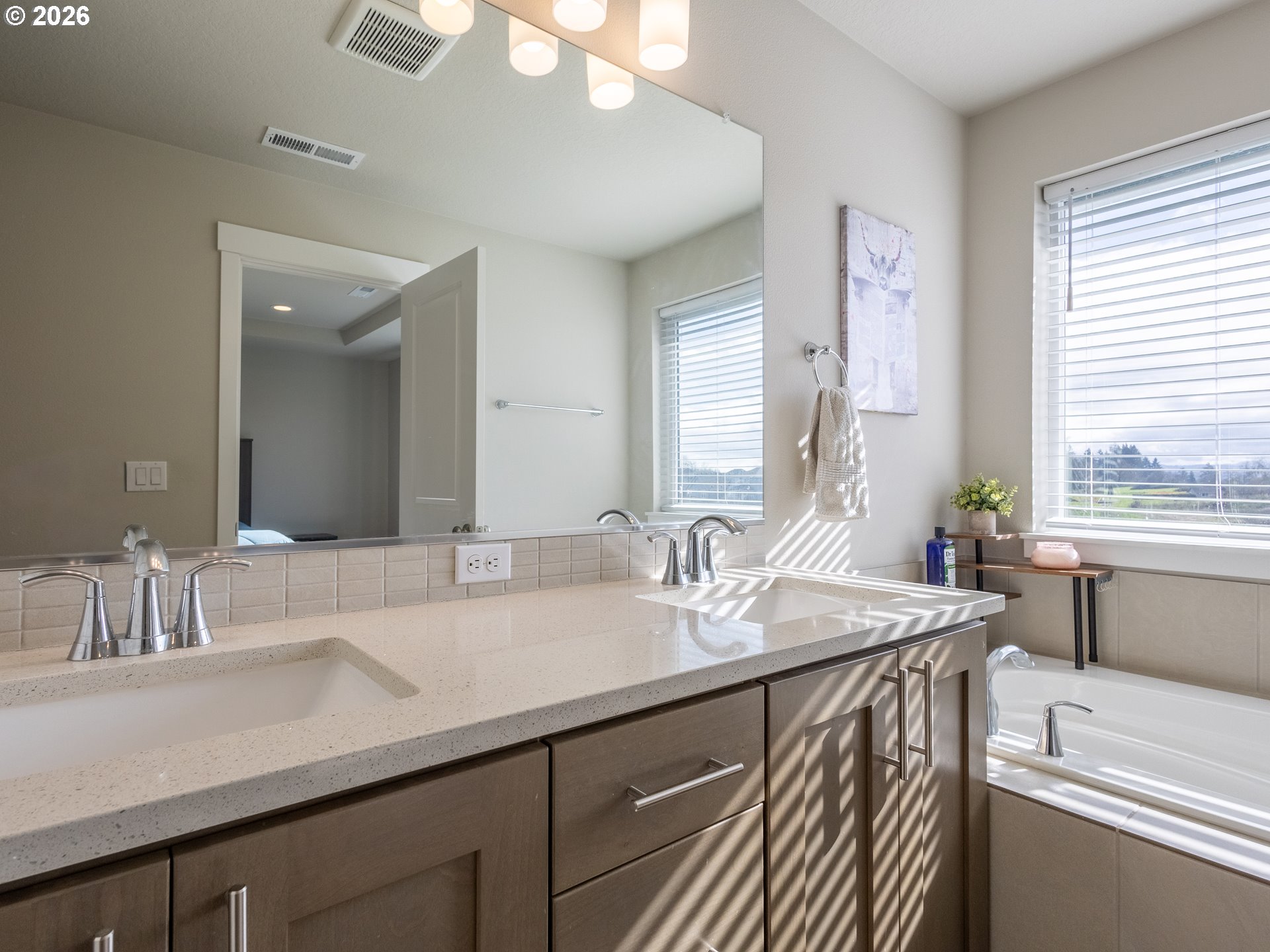 8827 North 1st Circle Ridgefield, WA 98642 - Photo 20 of 38 a bathroom with a sink double vanity and a bathtub