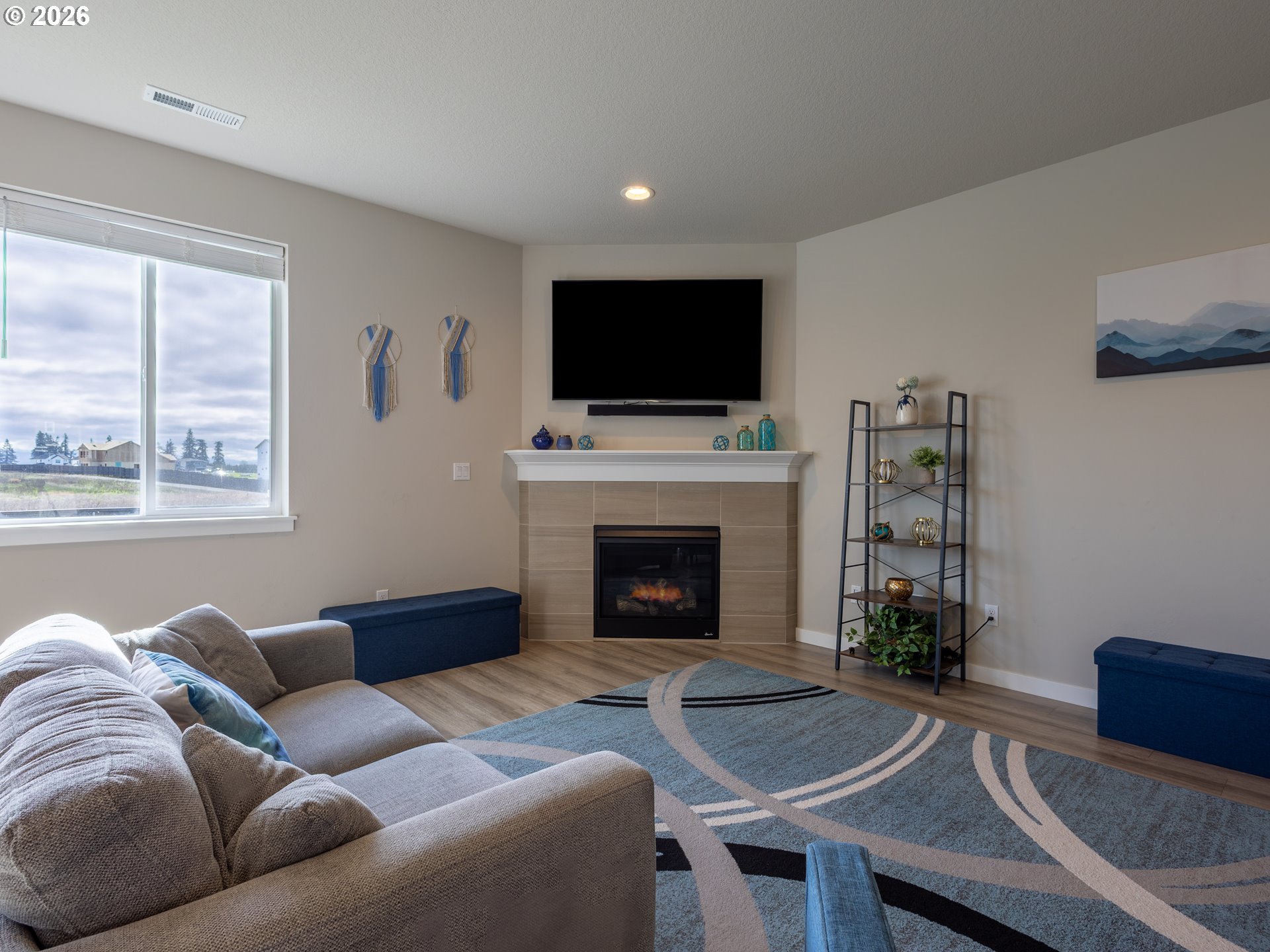8827 North 1st Circle Ridgefield, WA 98642 - Photo 6 of 38 a living room with furniture a flat screen tv and a fireplace