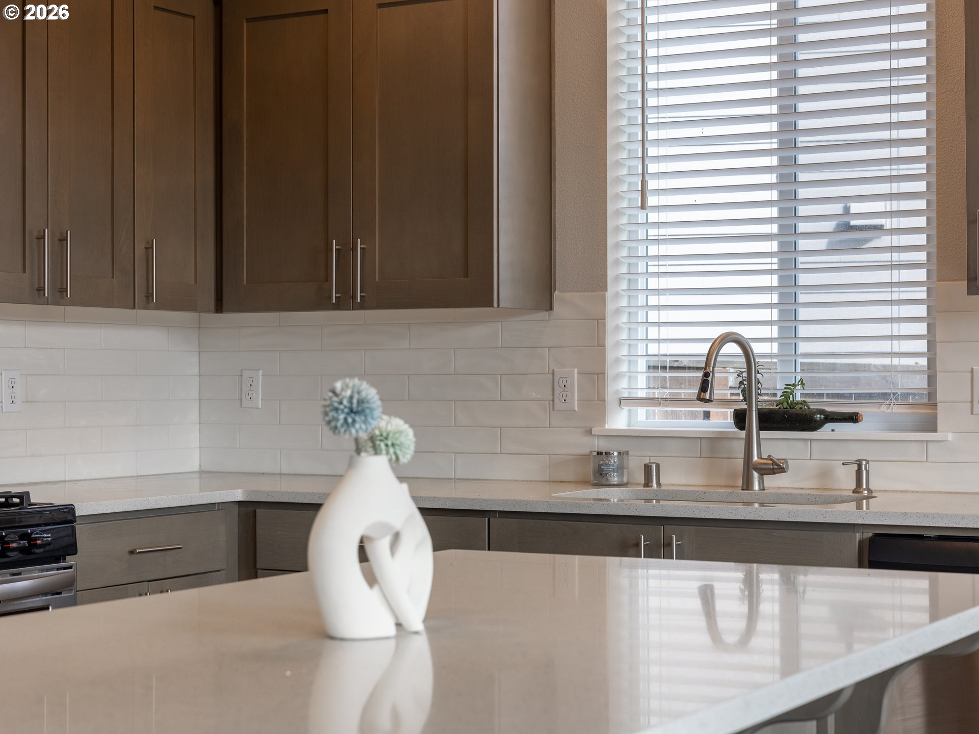 8827 North 1st Circle Ridgefield, WA 98642 - Photo 10 of 38 a kitchen with a sink and a white wooden cabinets