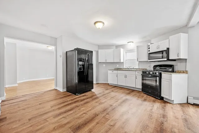 a kitchen with stainless steel appliances a refrigerator and a stove top oven