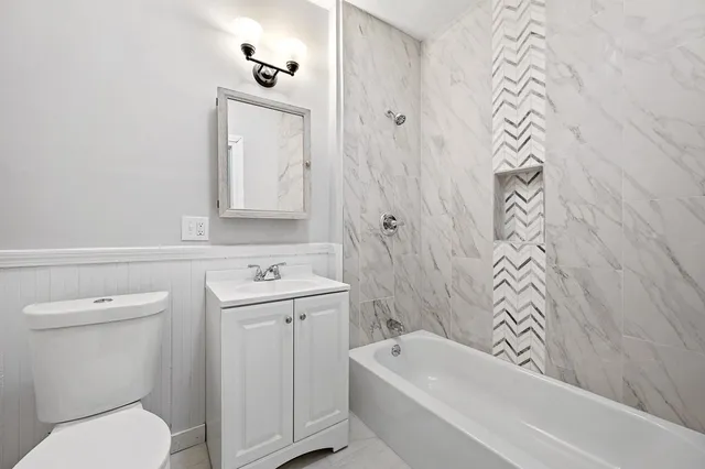 a bathroom with a sink a toilet and a bathtub