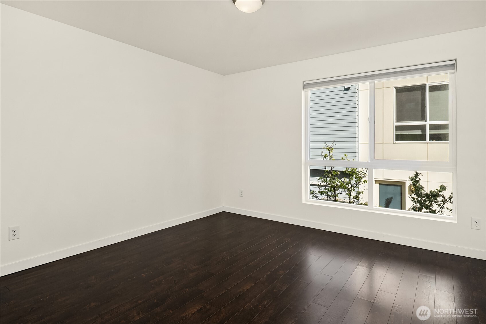 3631 Courtland Place South, Unit B Seattle, WA 98144 - Photo 15 of 27 an empty room with wooden floor and windows