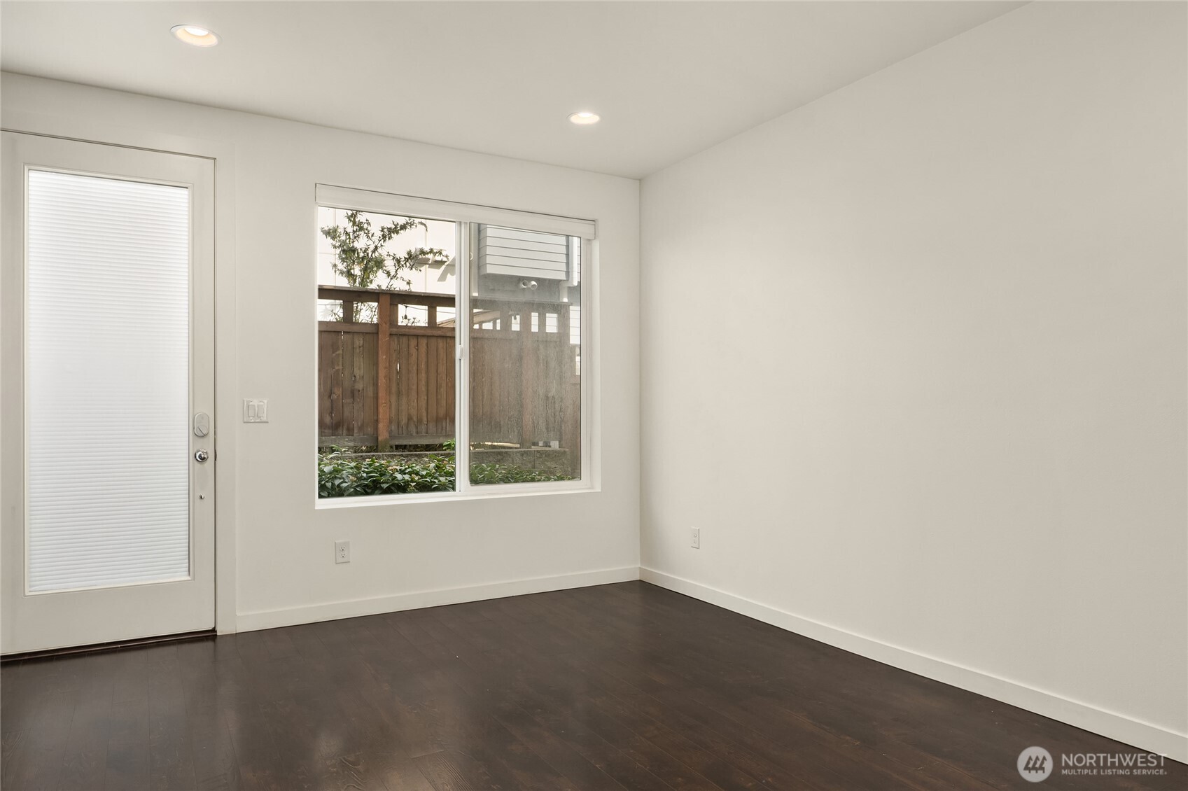 3631 Courtland Place South, Unit B Seattle, WA 98144 - Photo 8 of 27 an empty room with wooden floor and a window