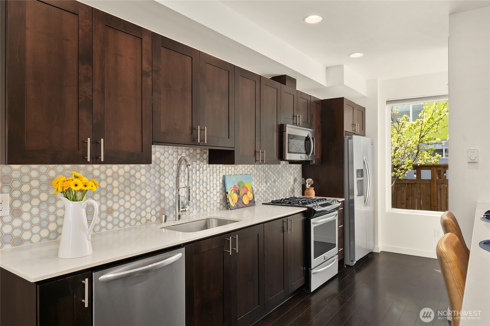 3631 Courtland Place South, Unit B Seattle, WA 98144 - Photo 9 of 27 a kitchen with stainless steel appliances kitchen island granite countertop a sink a stove and a refrigerator