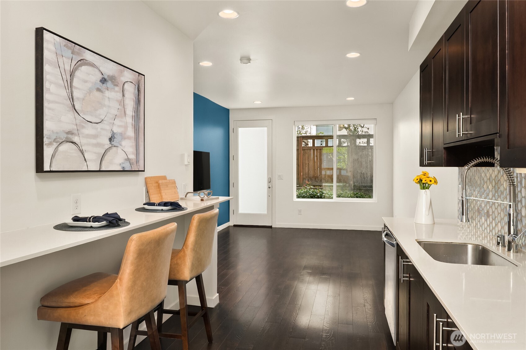 3631 Courtland Place South, Unit B Seattle, WA 98144 - Photo 10 of 27 a kitchen with stainless steel appliances a stove a sink a refrigerator and wooden floor
