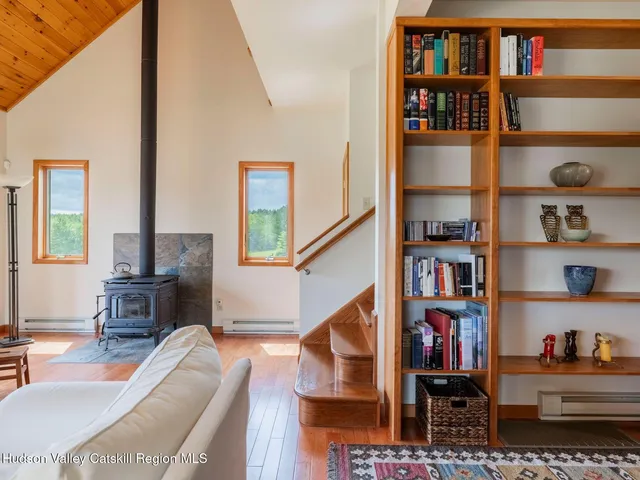 a living room with lots of furniture and a book shelf
