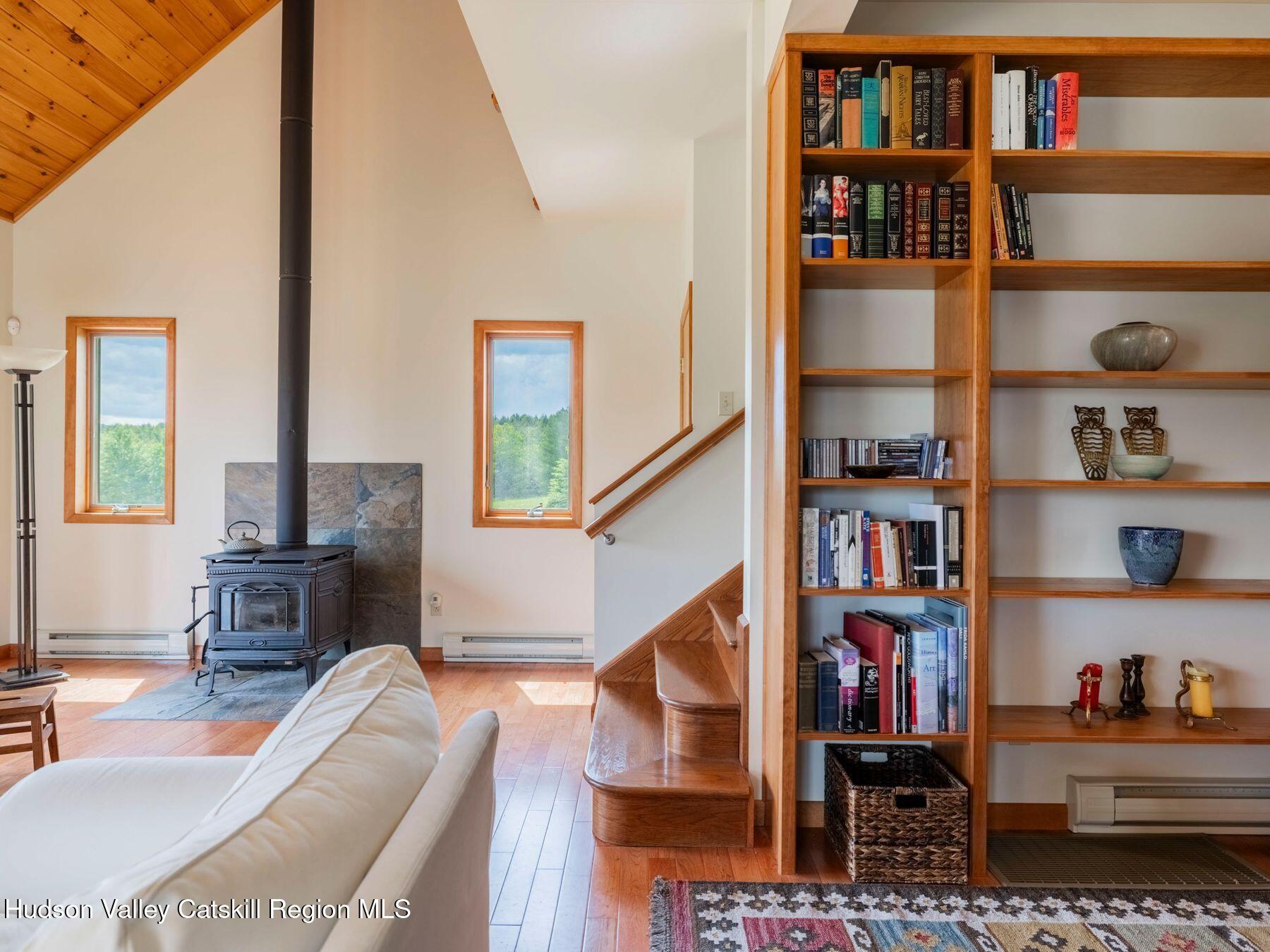5147 Rte 23c Jewett, NY 12444 - Photo 11 of 54 a living room with lots of furniture and a book shelf