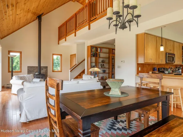 a dining room with furniture and wooden floor