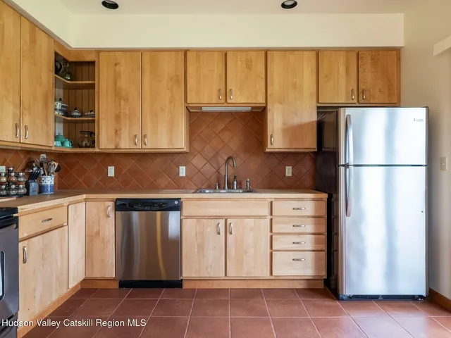 a kitchen with stainless steel appliances granite countertop a refrigerator sink and cabinets