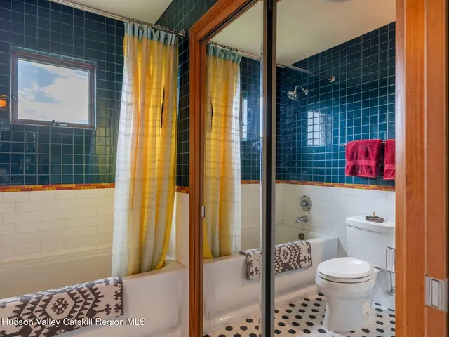 a bedroom with a bed and a night stand