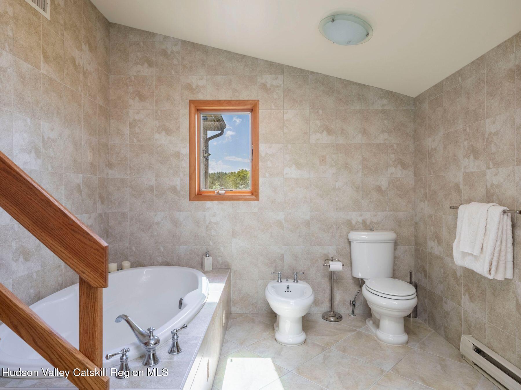 5147 Rte 23c Jewett, NY 12444 - Photo 35 of 54 a white toilet sitting next to a bathroom sink and a granite floor