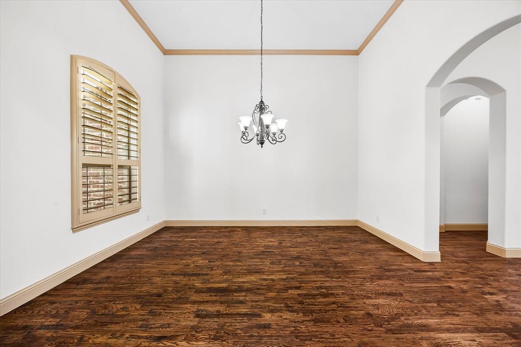 6814 Springwood Lane Garland, TX 75044 - Photo 7 of 35 a view of a room with wooden floor and windows