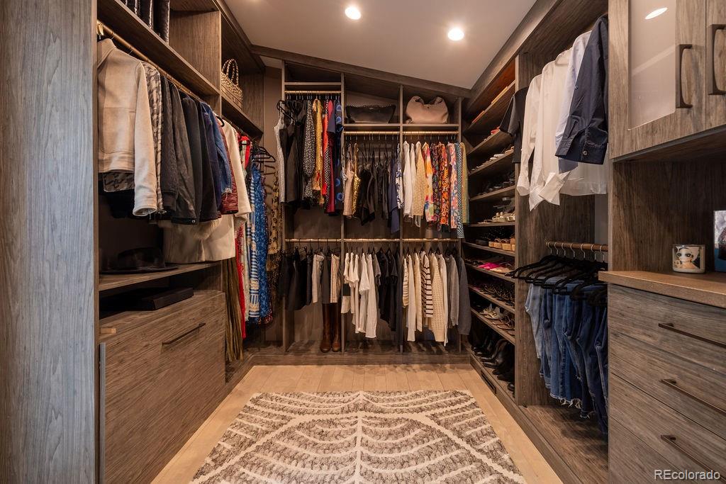 5151 West Wagon Trail Road Bow Mar, CO 80123 - Photo 23 of 50 a view of walk in closet with clothes and shoes