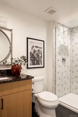 a view of a kitchen with furniture and refrigerator
