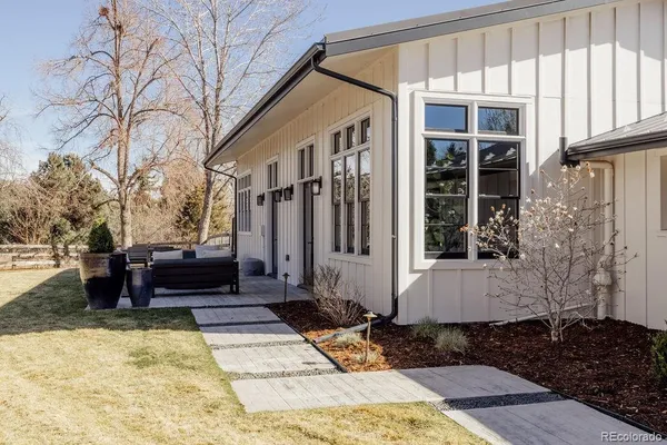 a view of a house with backyard and sitting area