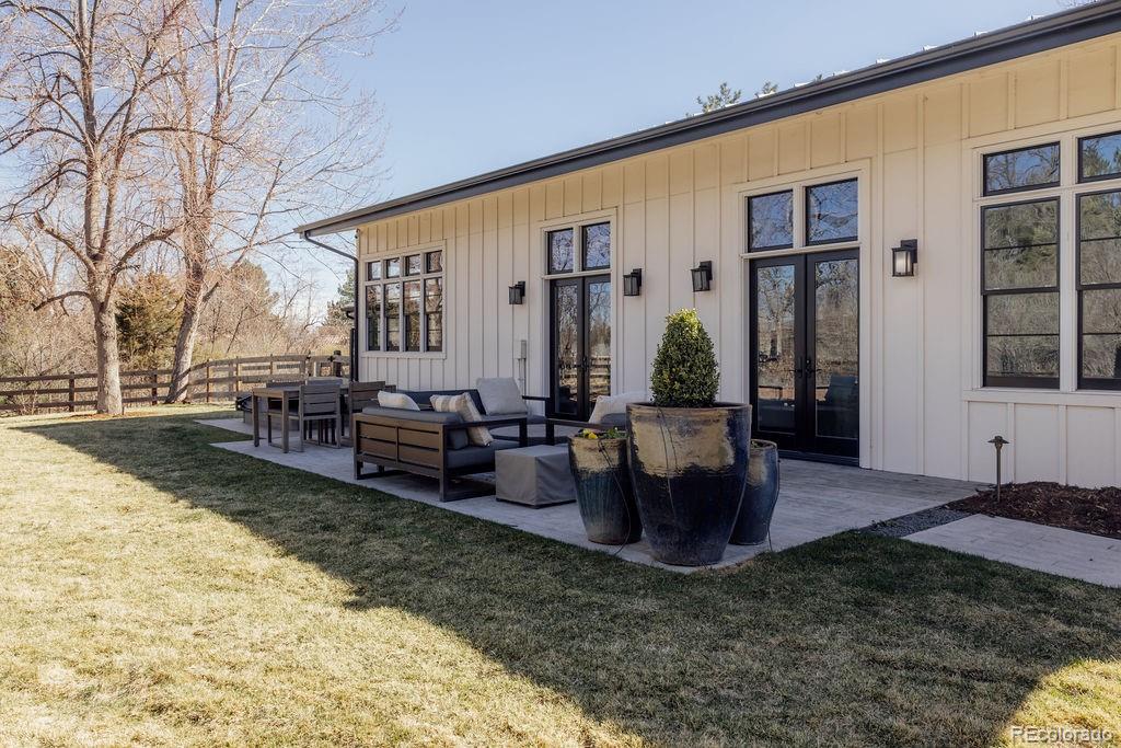 5151 West Wagon Trail Road Bow Mar, CO 80123 - Photo 43 of 50 a view of a house with backyard and sitting area