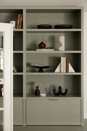 a shelf with cup and plates