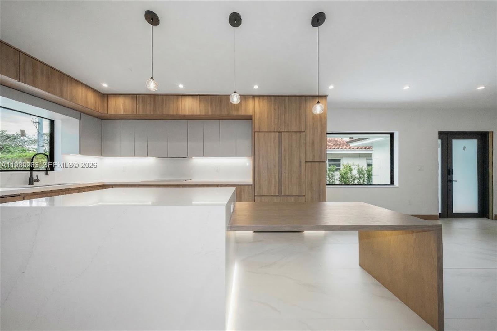 4241 Red Road Coral Gables, FL 33146 - Photo 11 of 51 a view of a kitchen with a refrigerator a sink a counter top space and cabinets