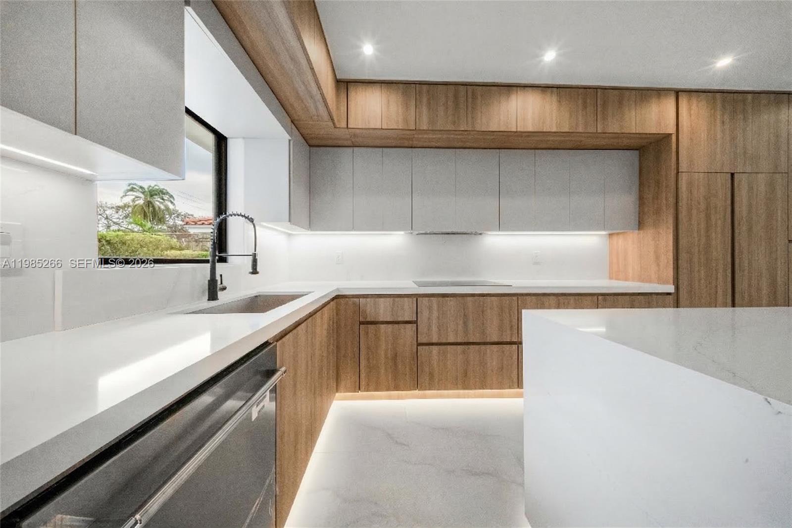 4241 Red Road Coral Gables, FL 33146 - Photo 14 of 51 a kitchen with kitchen island granite countertop a sink and a stove top oven