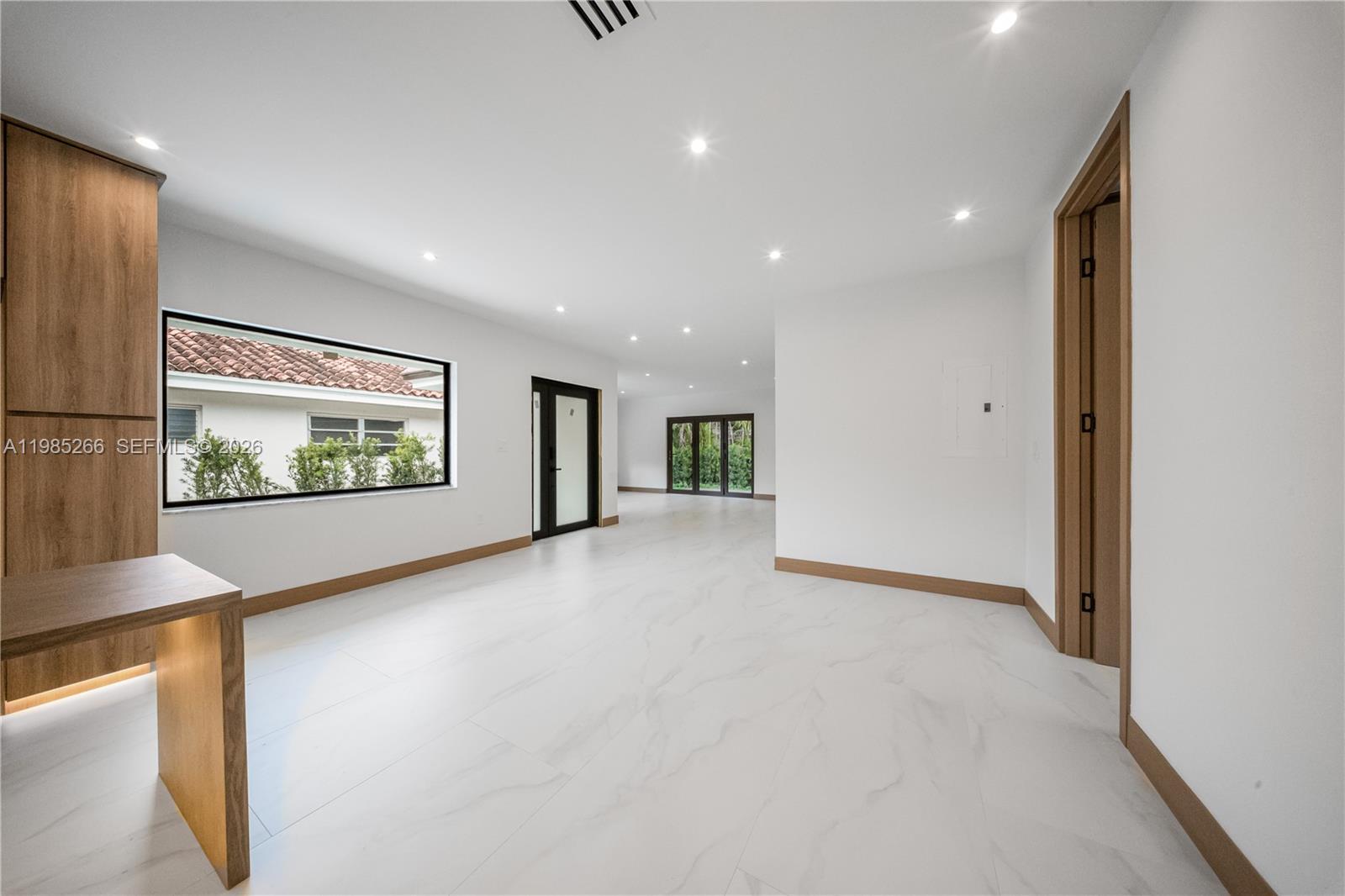 4241 Red Road Coral Gables, FL 33146 - Photo 16 of 51 a view of a hallway with two windows and a kitchen