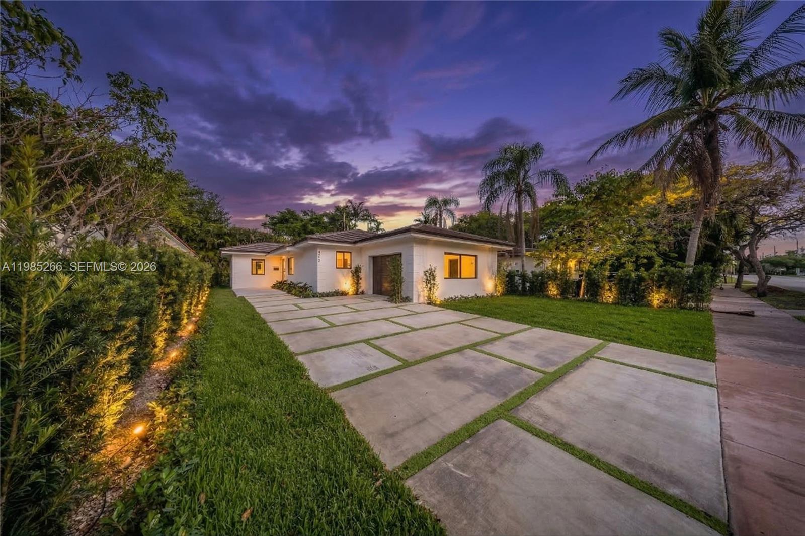 4241 Red Road Coral Gables, FL 33146 - Photo 2 of 51 a front view of a house with a yard and a garage
