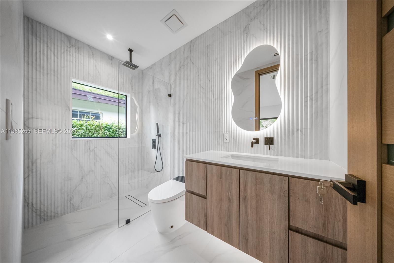 4241 Red Road Coral Gables, FL 33146 - Photo 31 of 51 a bathroom with a toilet a sink and mirror